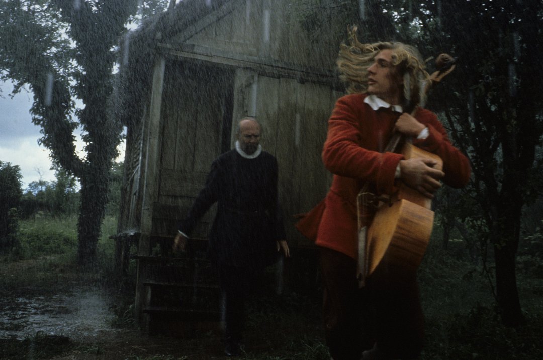 Still from Tous les Matins du Monde: the young Marin Marais runs through the rain, viol in arms
